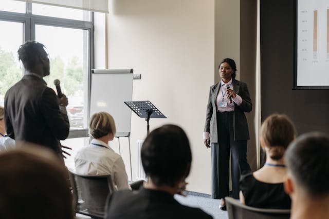Man and woman talking while holding a microphone
